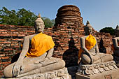 Ayutthaya, Thailand. Wat Yai Chai Mongkhon, saffron-draped Buddha statues inside the temple compound.